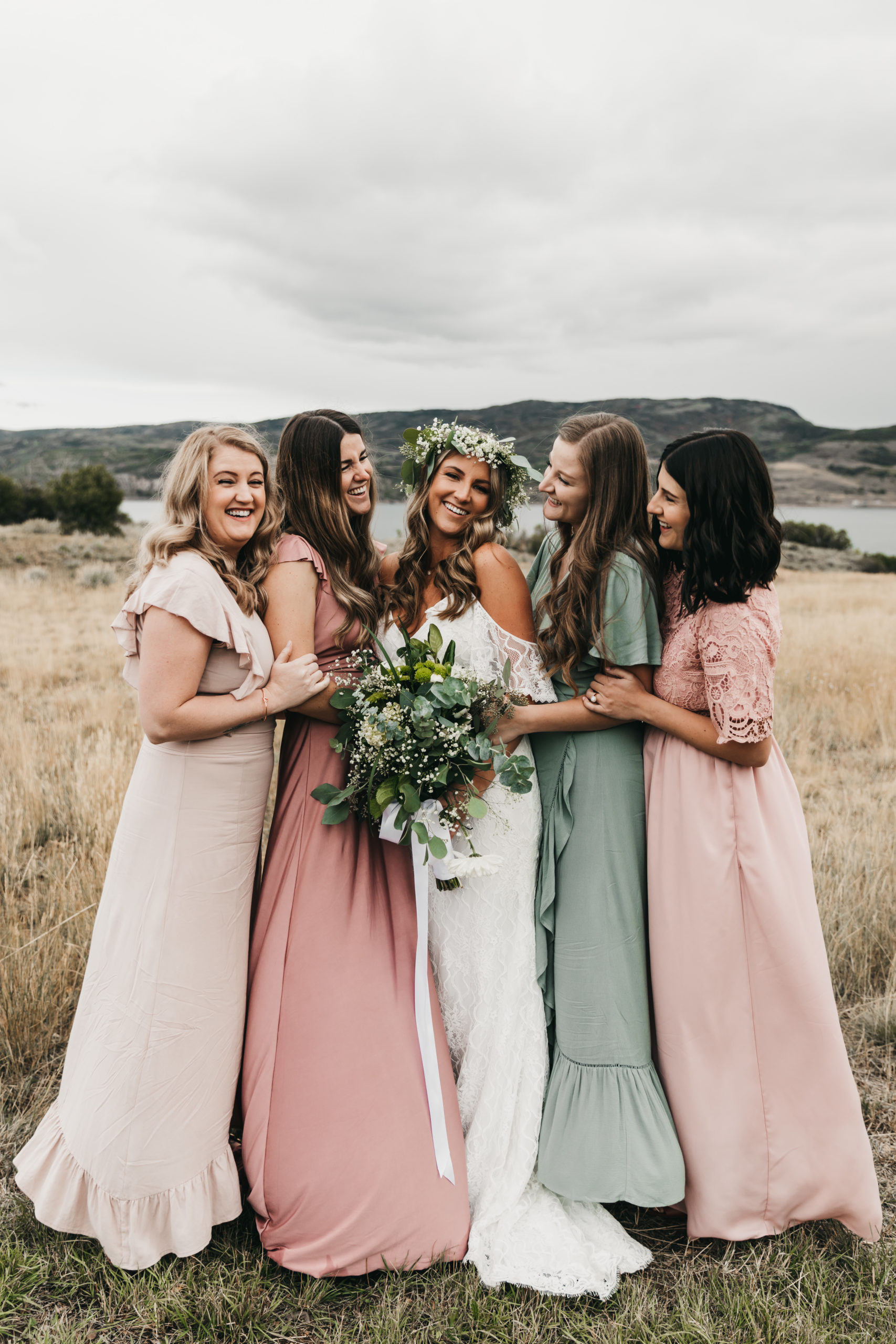 Bridesmaids in sage green and blush mismatch dresses