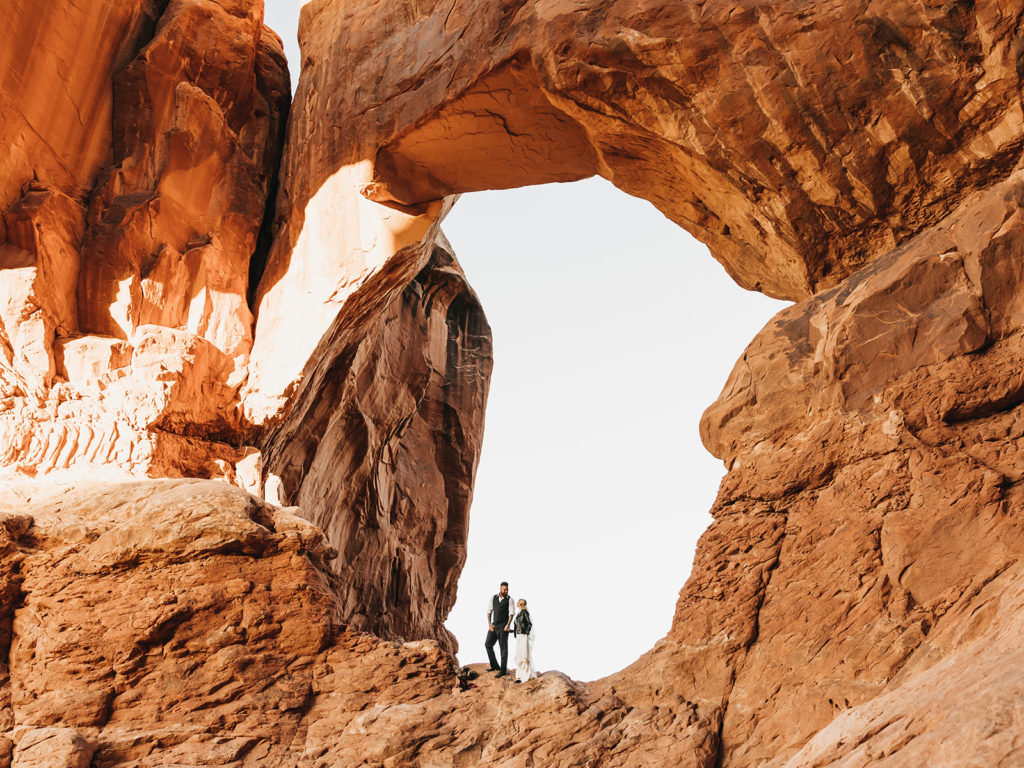 Couple elopes in best places in utah to elope in between rock arch in Moab Utah