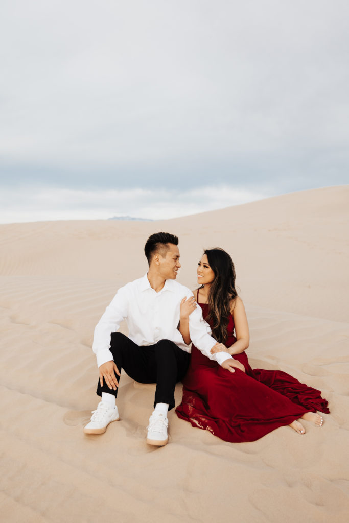 couple in red dress in little sahara sand dunes photography