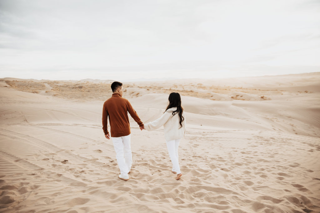 couple walking on little sahara sand dunes