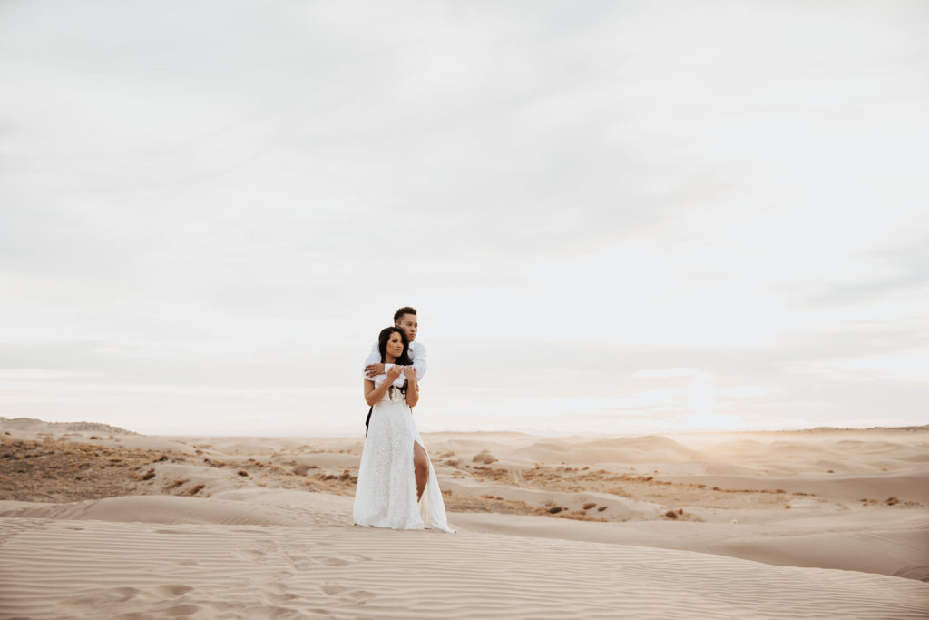 couple in white at little sahara sand dunes nephi utah