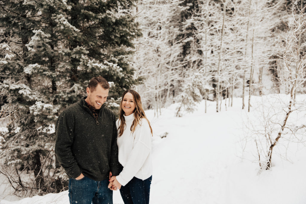 couple laughs candidly in Utah mountains