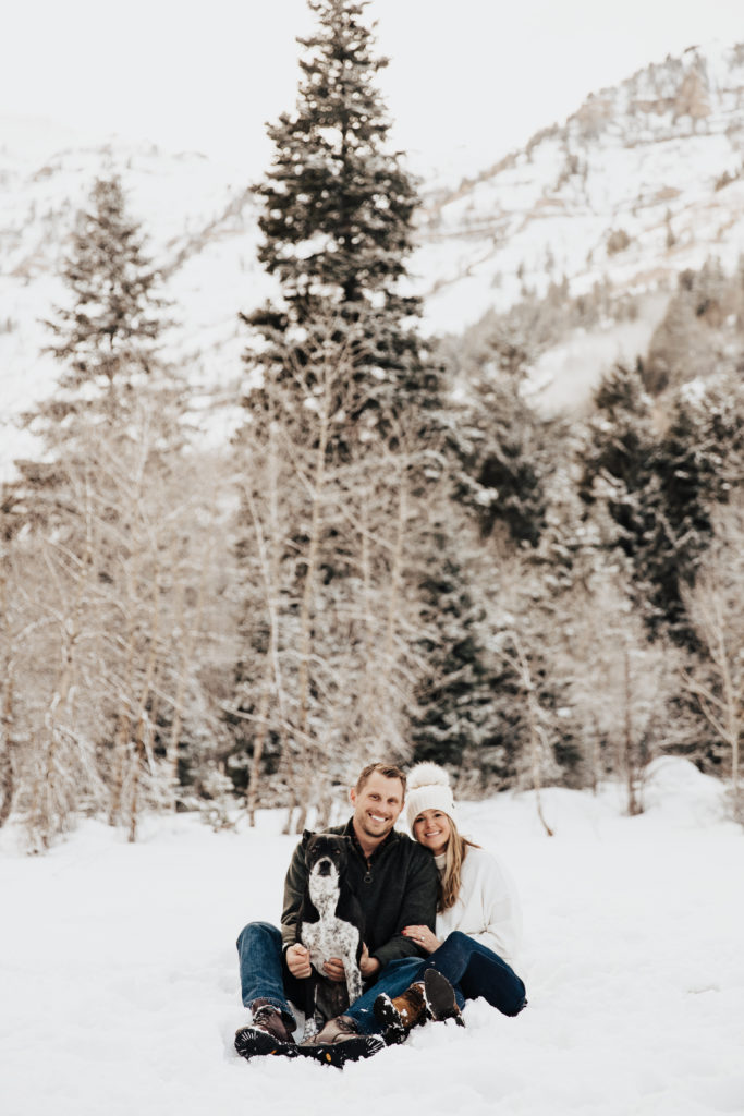 engagement photos in the winter snow with their dog