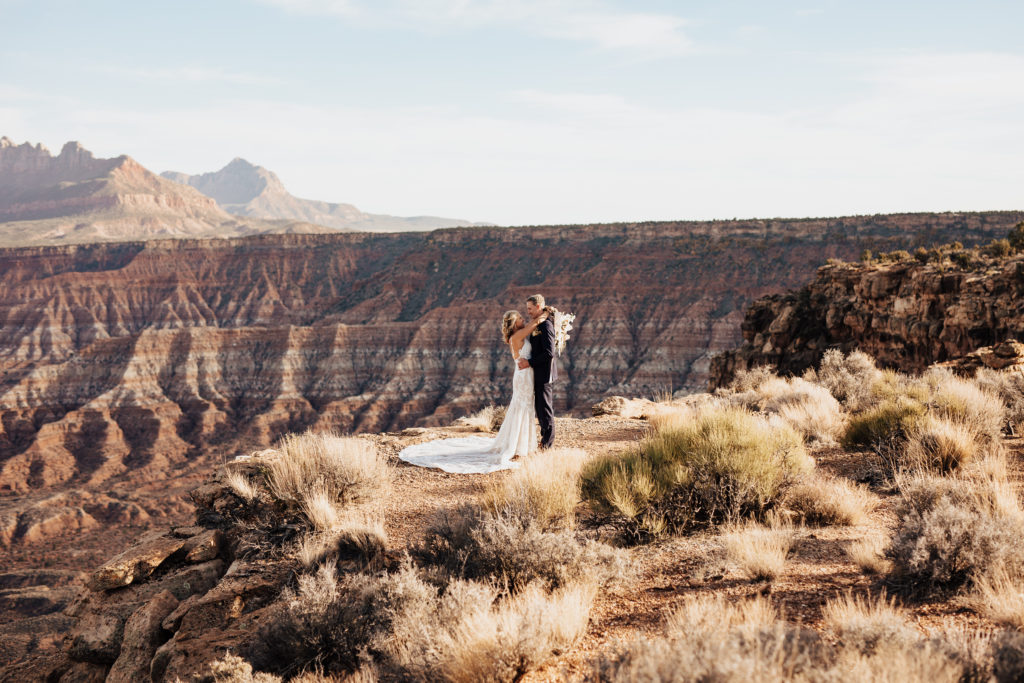 bride and groom overlooking zion plateau cliffs